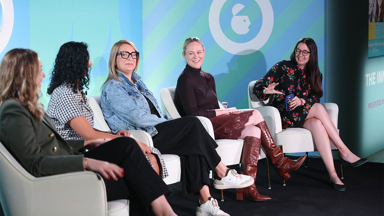 Speaker on the stage at Ad week new your panel titled "Navigating Economic Headwinds: Maximizing Ad Spend Through Smarter Measurement.