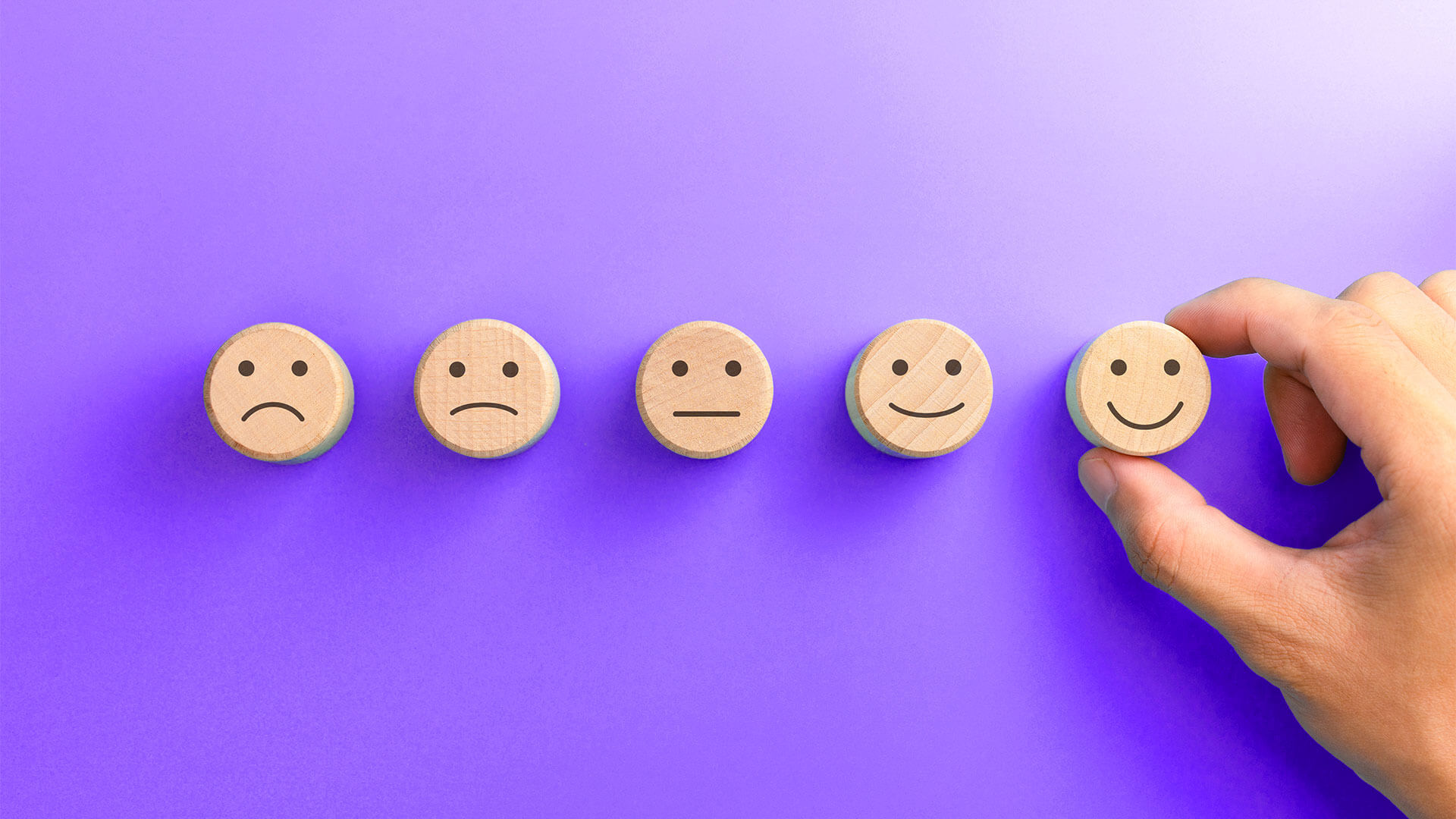 Hand adjusts smiley face token