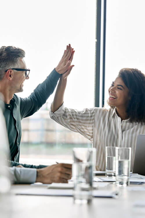 Two colleagues high five each other